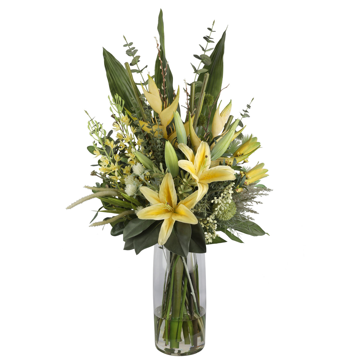 Yellow Lily and Heliconia Luminous Artificial Arrangement with soft yellow asiatic lilies, heliconia spikes, white globe thistle, green hypericum berries, and tropical foliage in a tall glass cylinder vase
