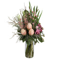 Blush King Protea and Orchid Wild Romance Artificial Arrangement with three blush pink king proteas, pink gladioli, cymbidium orchids, mauve orchids, and mixed foliage in a tall glass cylinder vase