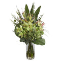 Green Cymbidium Orchid and Hydrangea Tropical Artificial Arrangement with green cymbidium orchids, green hydrangeas, pink protea buds, heliconia spikes, fan palm leaf, and tropical foliage in a tall glass cylinder vase