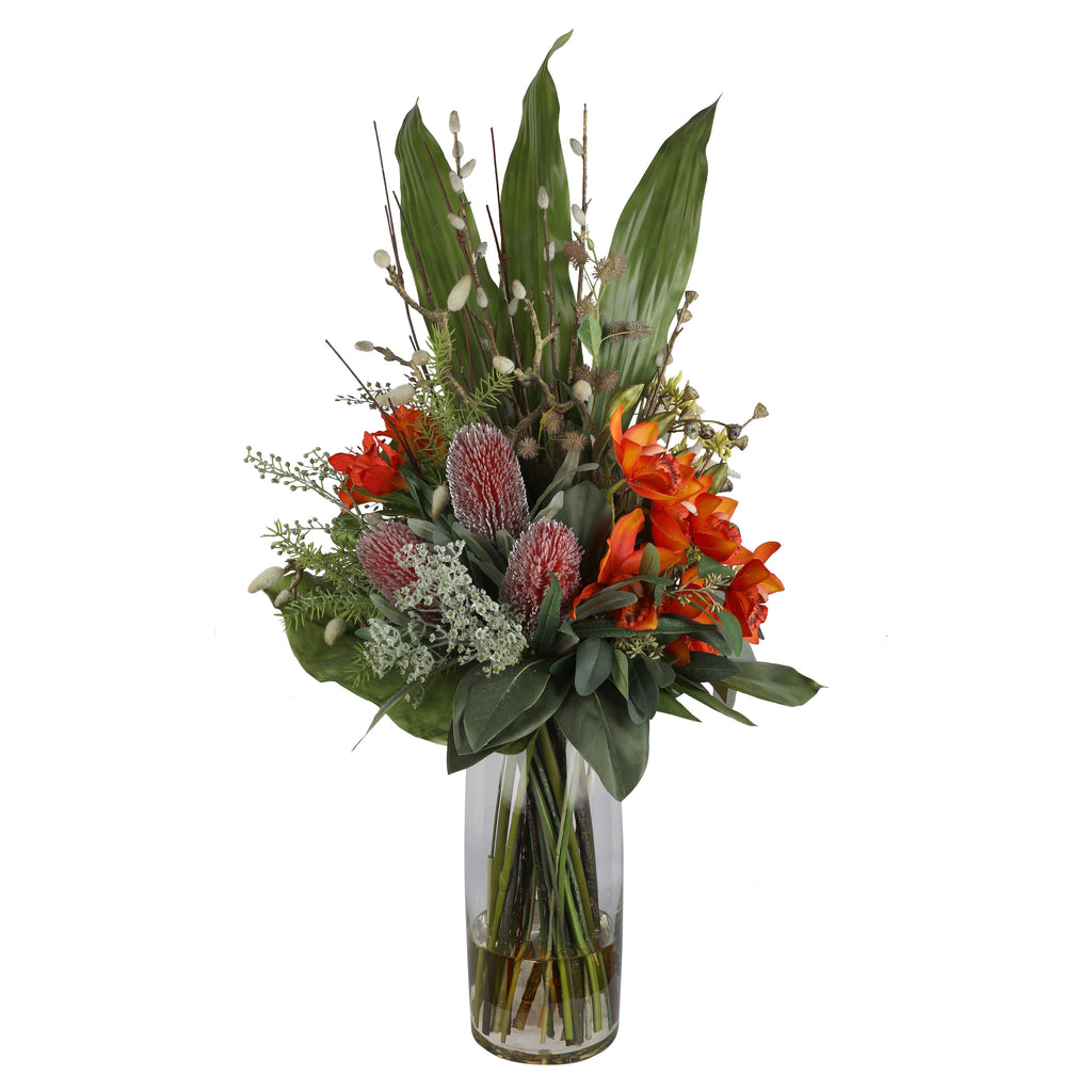 Orange Orchid and Pincushion Protea Wild Exotic Artificial Arrangement with orange cymbidium orchids, pink pincushion proteas, white ammi, pussy willow, and wild mixed greenery in a tall glass cylinder vase
