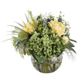Green Hydrangea and Yellow Peony Garden Artificial Arrangement with green hydrangeas, soft yellow peonies, white wax flowers, yellow solidago, and mixed greenery in a glass fishbowl vase