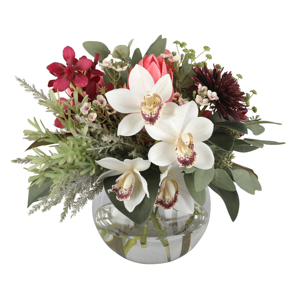 White Orchid and Burgundy Dahlia Luxe Artificial Arrangement with white cymbidium orchids, deep burgundy dahlias, crimson orchids, blush protea bud, and mixed greenery in a glass fishbowl vase