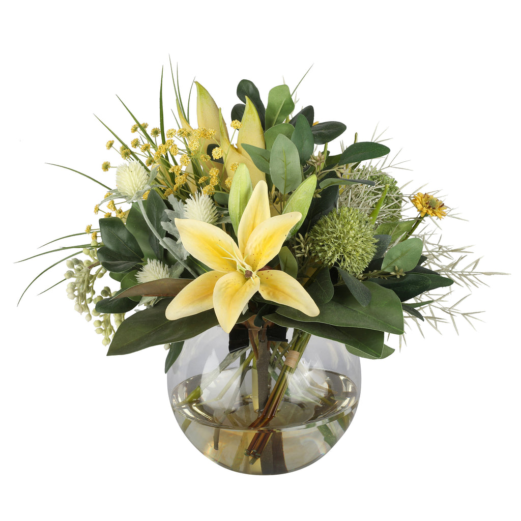 Yellow Lily and Wattle Botanical Artificial Arrangement with soft yellow asiatic lily, green allium balls, white globe thistle, yellow wattle, and mixed foliage in a glass fishbowl vase