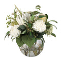 White Protea and Hydrangea Garden Elegance Artificial Arrangement with white king protea, white hydrangeas, golden banksia, white pampas grass, and mixed greenery in a glass fishbowl vase