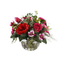 Crimson Passion Artificial Bouquet with red amaryllis, deep pink roses, magenta tulips, cosmos, and green berries in a glass fishbowl vase