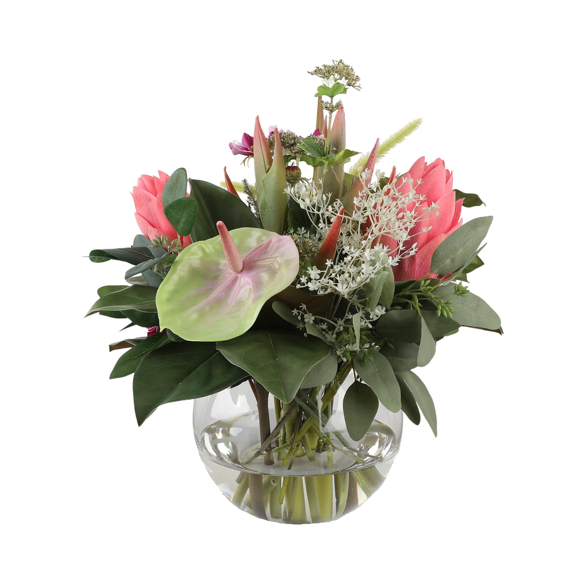 Tropical Coral Artificial Bouquet with coral proteas, pale green anthurium, pampas grass, white lace flowers, and tropical foliage in a glass fishbowl vase