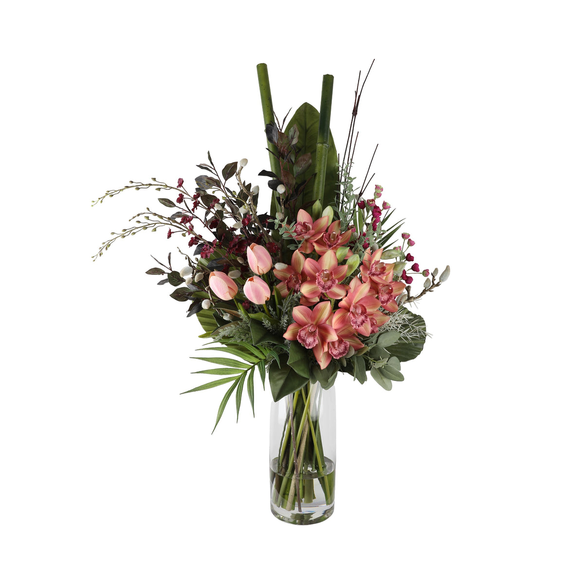 Peach Orchid and Tulip Artificial Arrangement with peach cymbidium orchids, pink tulips, red wax flowers, bamboo stalks, anthurium leaf, and dark twigs in a tall glass cylinder vase