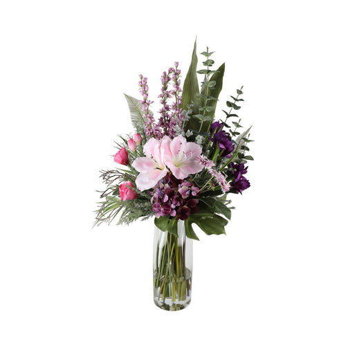 Purple Reign Artificial Arrangement with pink amaryllis, deep purple lisianthus, purple hydrangea, pink peonies, lavender delphiniums, monstera leaf, and ferns in a tall glass cylinder vase