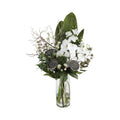 Zen Orchid and Lotus Artificial Arrangement with white phalaenopsis orchids, dried lotus seed pods, silver eryngium thistle, white wax flowers, silver branches, and magnolia leaf in a tall glass cylinder vase