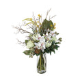 Bush Luxe Artificial Arrangement with white cymbidium orchids, white king proteas, green artichokes, yellow oncidium orchids, silver branches, and pampas grass in a tall glass cylinder vase