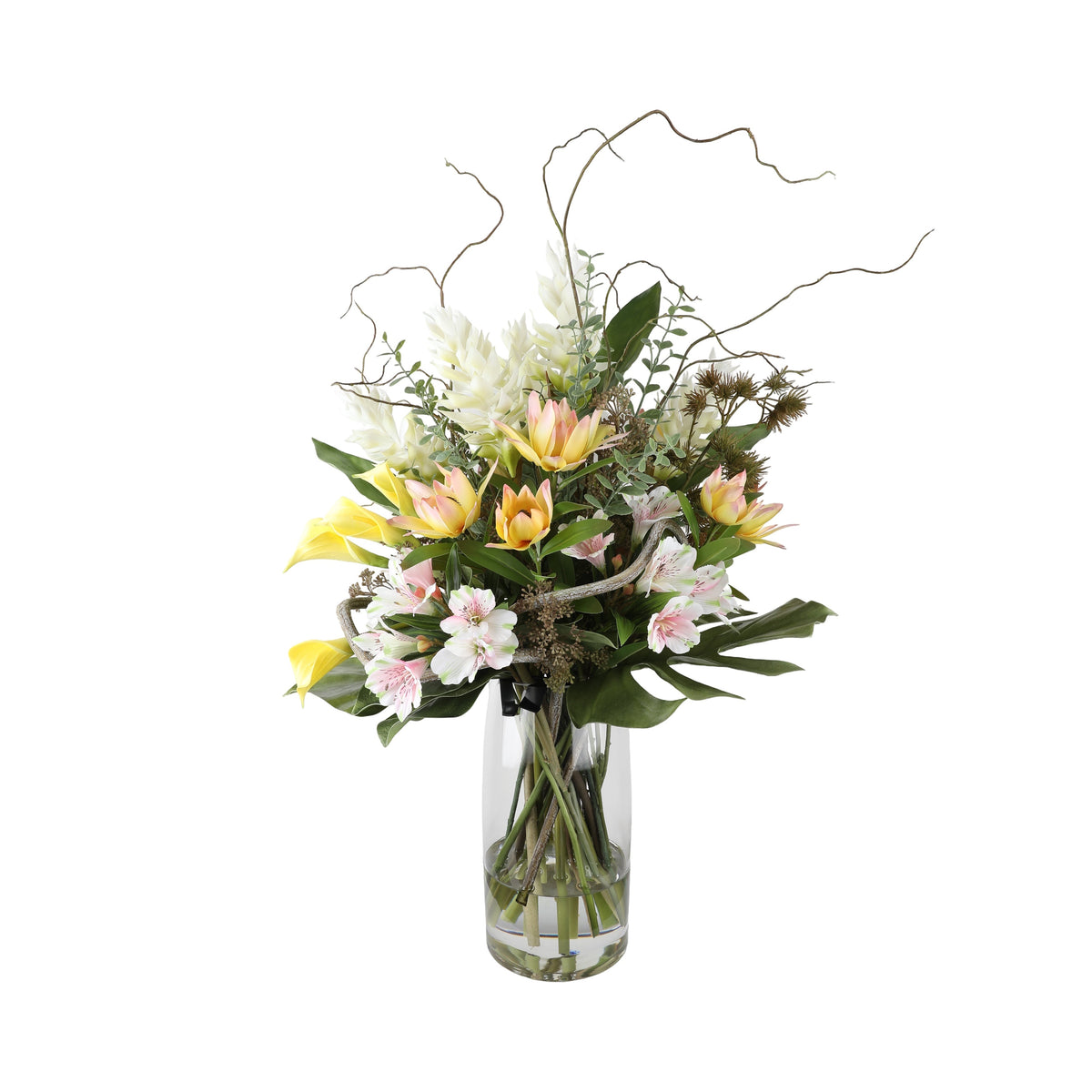 Spring Whisper Artificial Arrangement with peach tulip proteas, yellow calla lilies, pink alstroemeria, white gladiolus, pampas grass, and curly willow in a tall glass cylinder vase