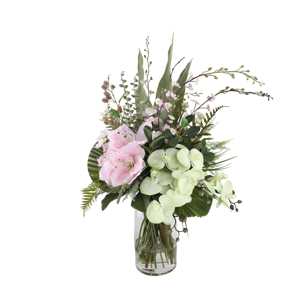 Pink Amaryllis and Orchid Artificial Arrangement with blush pink amaryllis, white phalaenopsis orchids, pink wax flowers, budding branches, and tropical foliage in a tall glass cylinder vase