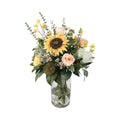 Sunflower and Peach Rose Artificial Bouquet with large sunflower, peach roses, white king protea, green allium, yellow wax flowers, and eucalyptus in a glass cylinder vase