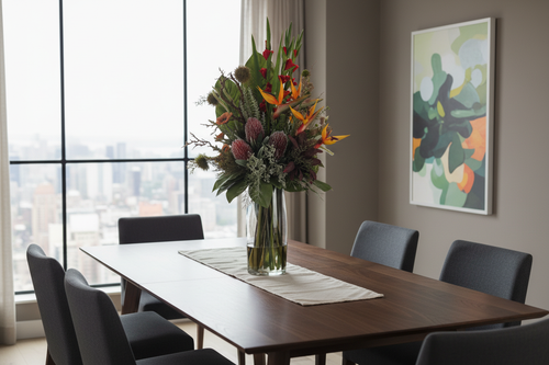 Bird of Paradise and Banksia Tropical Showpiece artificial arrangement on a dining table