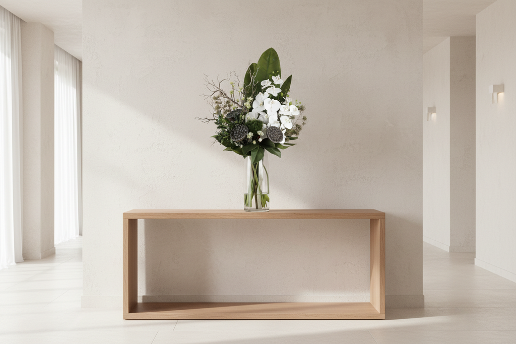 Zen Orchid and Lotus large artificial arrangement on a minimalist entryway console, grounded in a tall glass cylinder vase, 90 x 40 cm