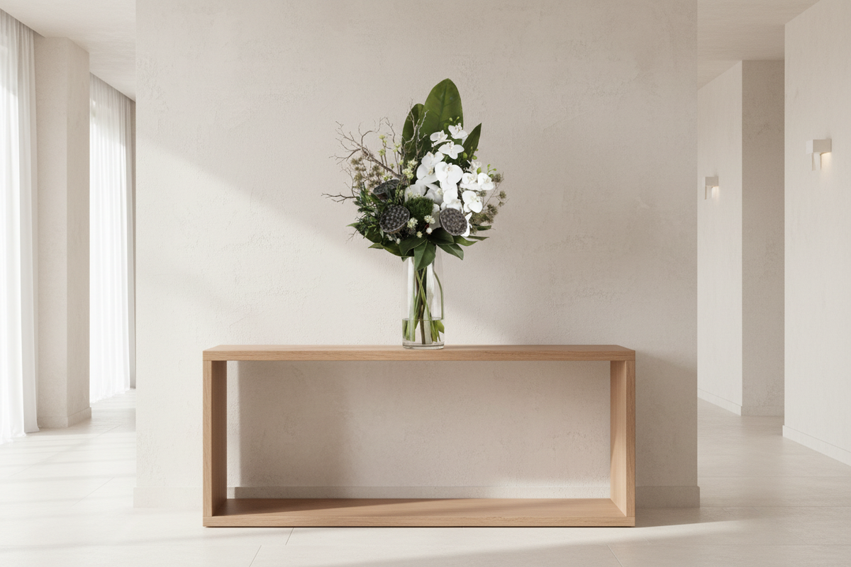 Zen Orchid and Lotus large artificial arrangement on a minimalist entryway console, grounded in a tall glass cylinder vase, 90 x 40 cm
